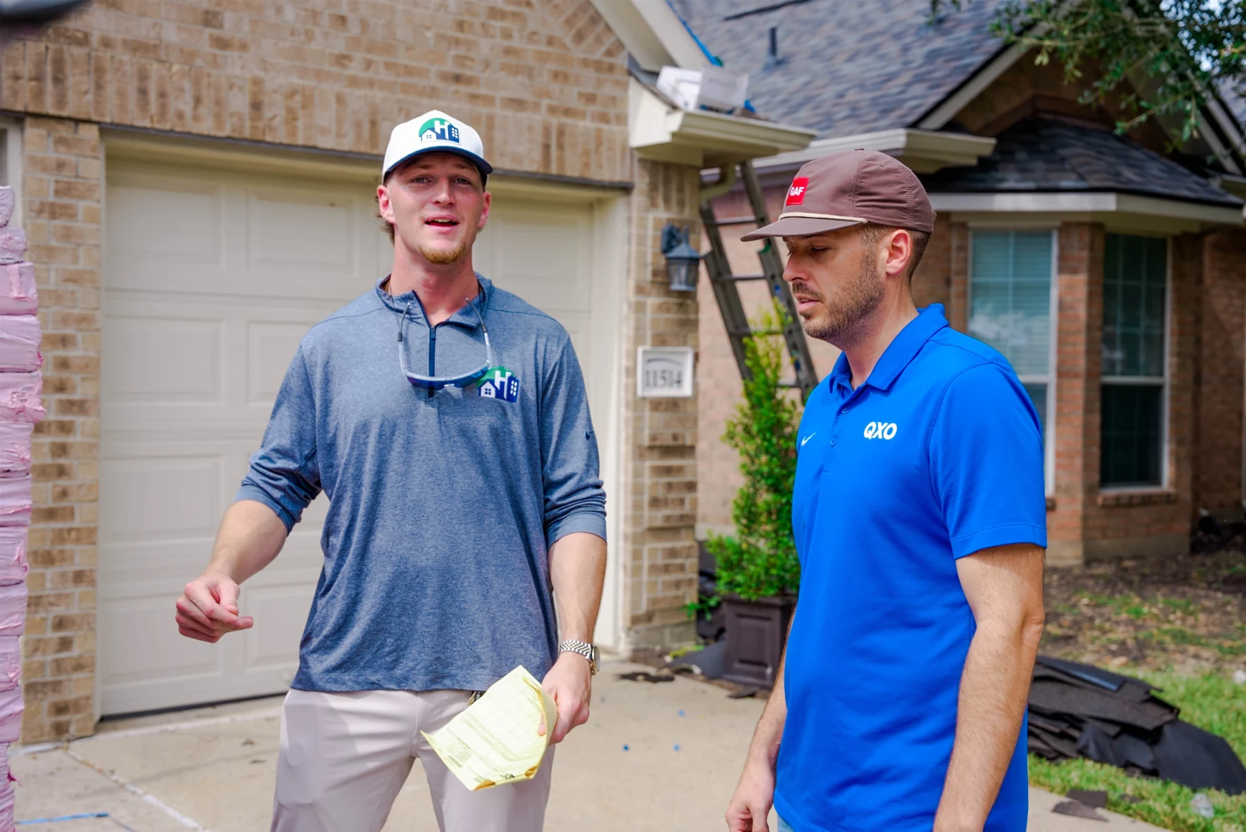 Chance Hill discussing work on site at a roofing project